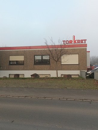 Foto von einem Gebäude mit Torkret Logo